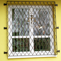 Hand-forged scales – a symbol of medicine – on the grilles of a pharmacy Hand-forged scales – a symbol of medicine – on the grilles of a pharmacy